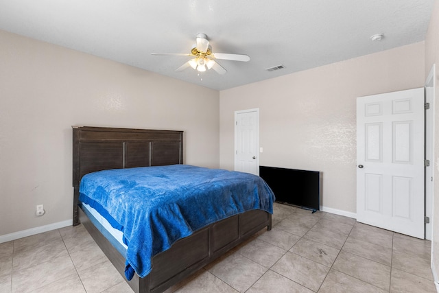 tiled bedroom featuring ceiling fan