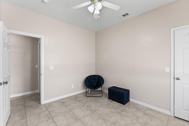 unfurnished room with ceiling fan and light tile patterned flooring