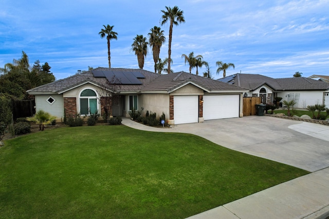 single story home featuring a garage, a front lawn, and solar panels