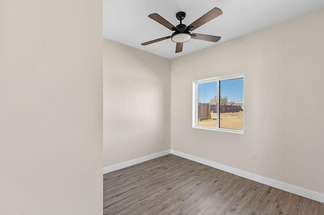 spare room with ceiling fan and wood-type flooring