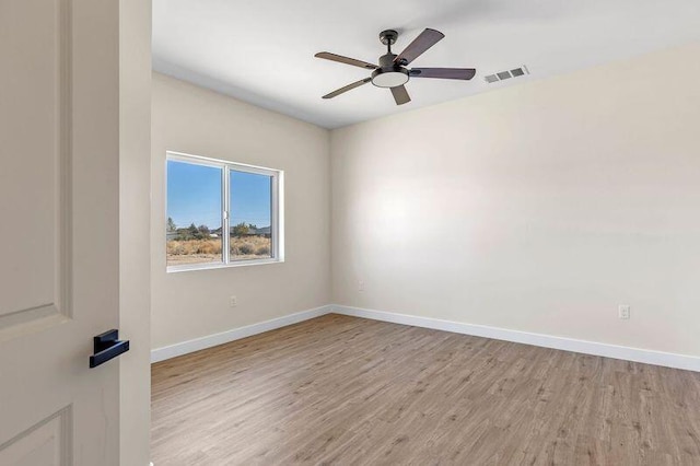 spare room with light wood-type flooring and ceiling fan