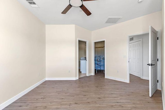 unfurnished bedroom featuring light wood-type flooring and ceiling fan