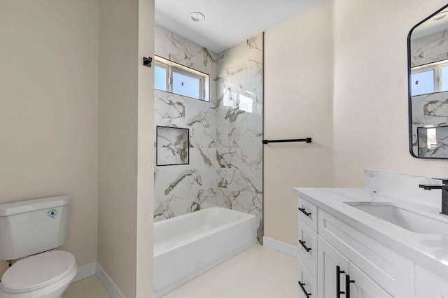 full bathroom featuring vanity, tiled shower / bath combo, and toilet