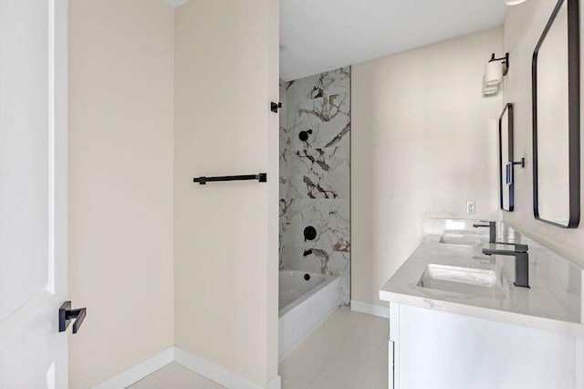 bathroom featuring tile patterned flooring, vanity, and tiled shower / bath