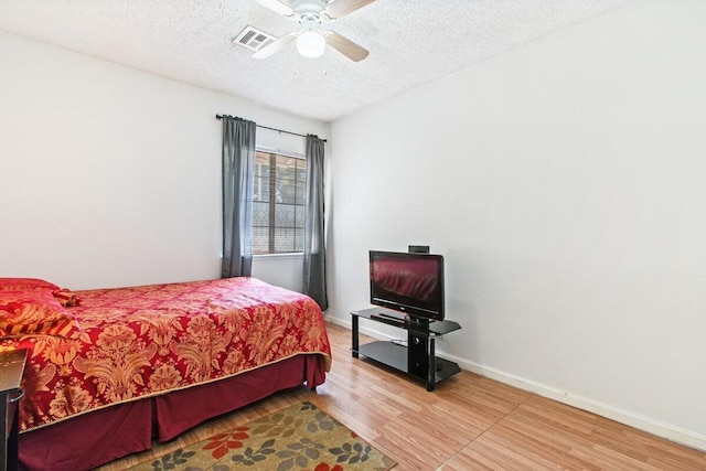 44605 Gillan Ave, Lancaster, CA 93535 - bedroom featuring wood finished floors, a textured ceiling, and a ceiling fan