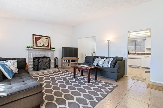 44605 Gillan Ave, Lancaster, CA 93535 - living room featuring light tile patterned floors, a textured ceiling, and a brick fireplace