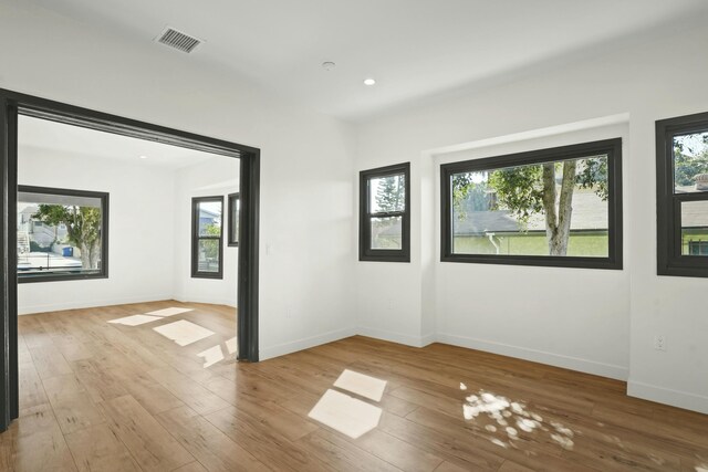 2745 Kenwood Ave, Los Angeles, CA 90007 - empty room with plenty of natural light, light wood-type flooring, visible vents, and baseboards