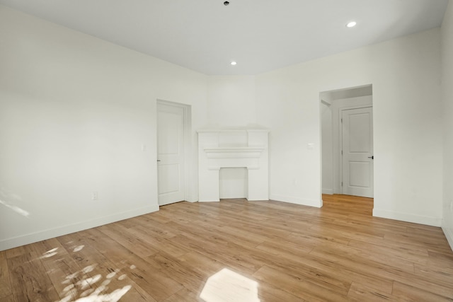 2745 Kenwood Ave, Los Angeles, CA 90007 - unfurnished living room with light wood-style floors, baseboards, and recessed lighting