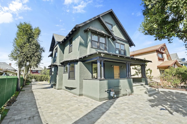 2745 Kenwood Ave, Los Angeles, CA 90007 - view of front facade with a porch, fence, and stucco siding