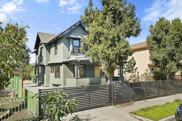 2745 Kenwood Ave, Los Angeles, CA 90007 - victorian home with a fenced front yard, a gate, and stucco siding