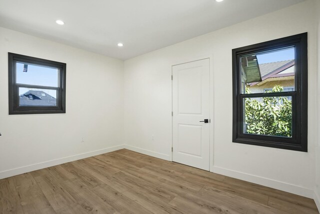 2745 Kenwood Ave, Los Angeles, CA 90007 - empty room with recessed lighting, wood finished floors, and baseboards