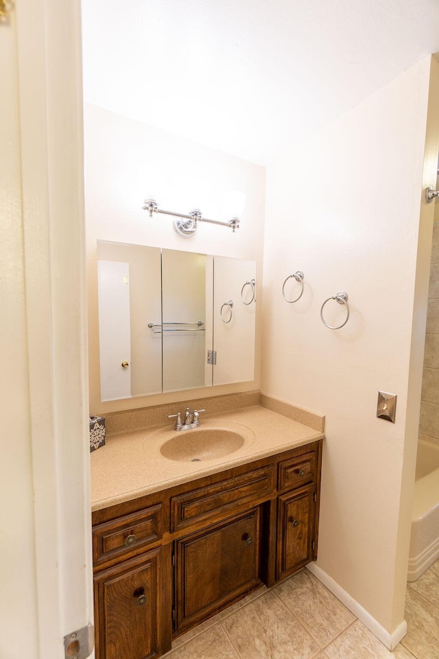 bathroom featuring tile patterned floors, baseboards, and vanity