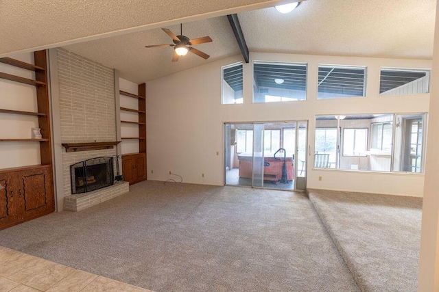 unfurnished living room with carpet floors, a fireplace, a textured ceiling, high vaulted ceiling, and beamed ceiling