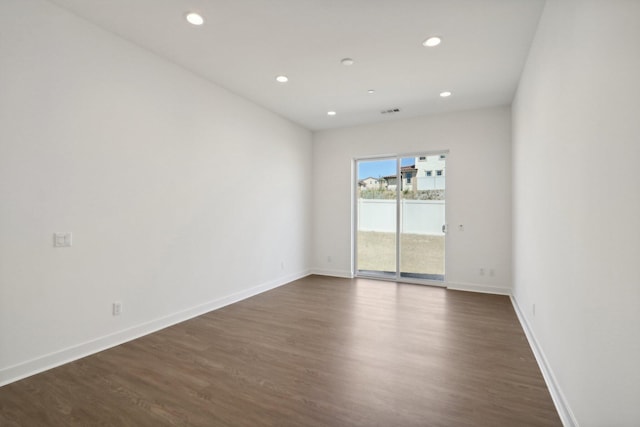 empty room with dark hardwood / wood-style floors