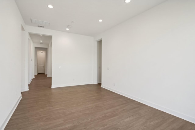 unfurnished room featuring dark wood-type flooring