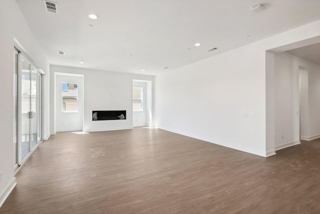 unfurnished living room with dark hardwood / wood-style floors