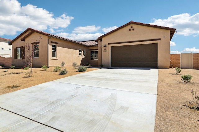 mediterranean / spanish home featuring a garage