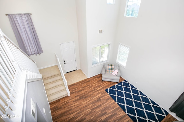 44927 Normandy Ln, Lancaster, CA 93536 - foyer featuring healthy amount of natural light, a towering ceiling, wood finished floors, and stairs