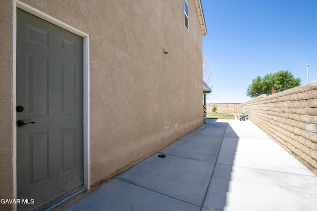 44927 Normandy Ln, Lancaster, CA 93536 - view of property exterior featuring stucco siding, a patio, and crawl space