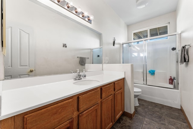 full bathroom with vanity, toilet, and combined bath / shower with glass door