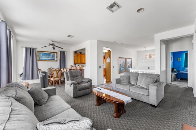 carpeted living room featuring ceiling fan