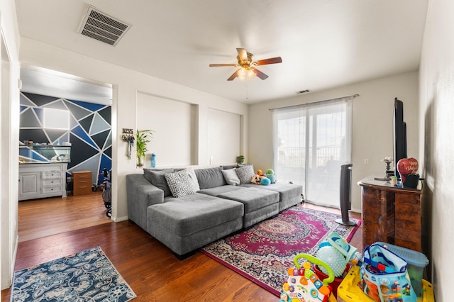 living room with ceiling fan and dark hardwood / wood-style floors