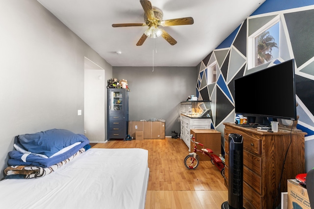 bedroom with light hardwood / wood-style flooring and ceiling fan