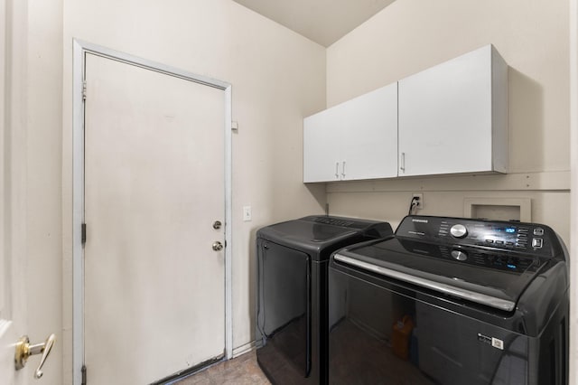 clothes washing area with cabinets and independent washer and dryer