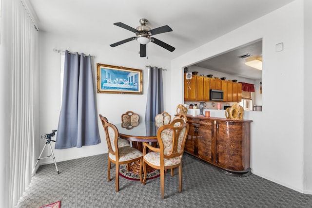 dining area featuring ceiling fan and carpet floors