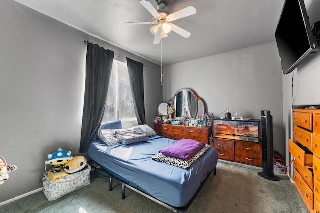 bedroom with ceiling fan and dark carpet