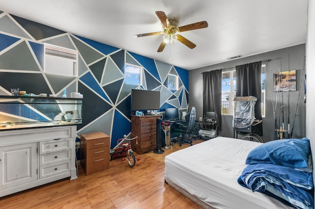 bedroom featuring ceiling fan and light hardwood / wood-style flooring