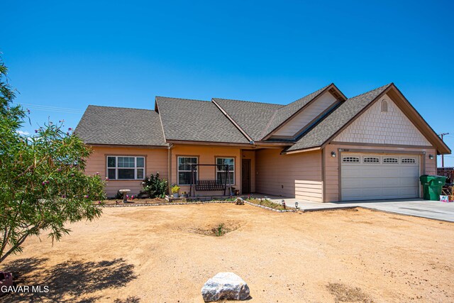 8801 Lupine Loop Dr, California City, CA 93505 - view of front of home with a garage, concrete driveway, and a shingled roof