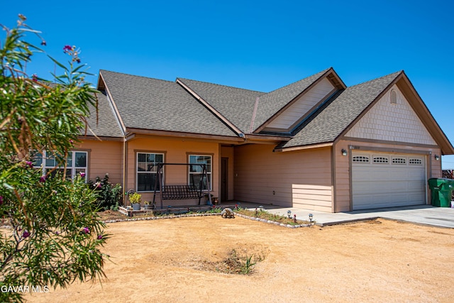 8801 Lupine Loop Dr, California City, CA 93505 - view of front of house with a garage, roof with shingles, and concrete driveway