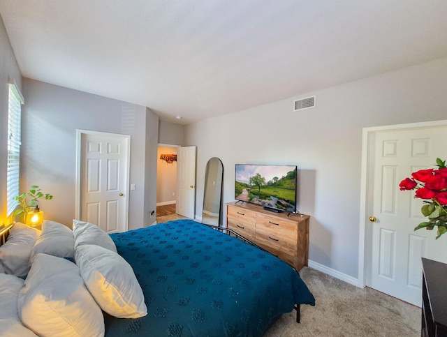 bedroom featuring light colored carpet, visible vents, vaulted ceiling, and baseboards