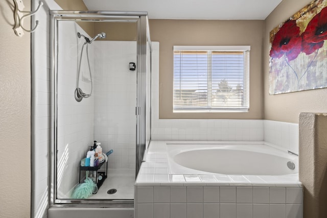 bathroom featuring separate shower and tub