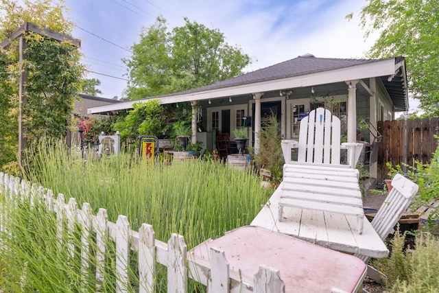 back of house featuring a porch