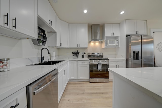 12871 W Osborne St, Arleta, CA 91331 - kitchen featuring wall chimney range hood, appliances with stainless steel finishes, white cabinets, and recessed lighting
