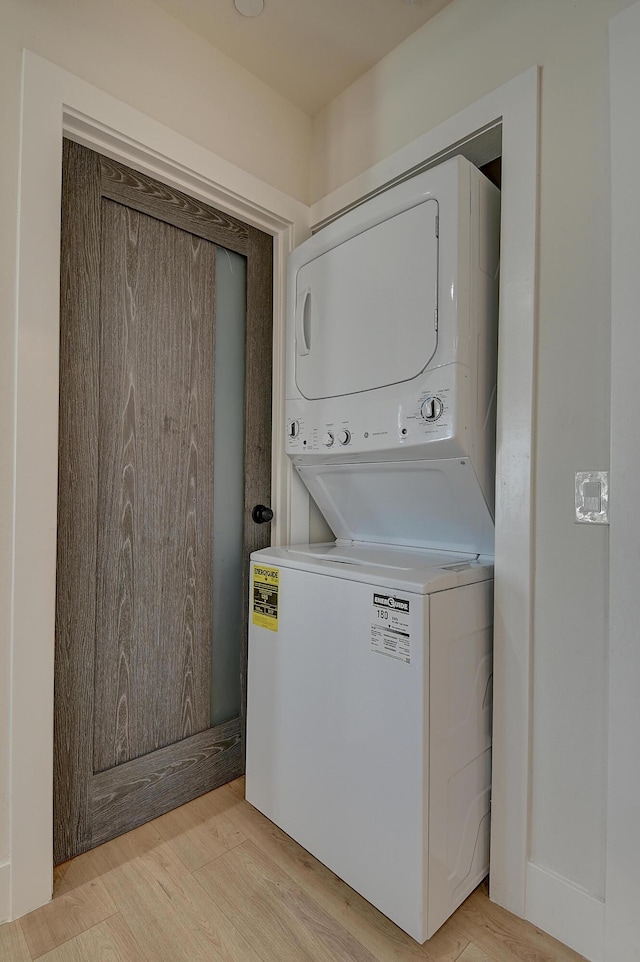 12871 W Osborne St, Arleta, CA 91331 - laundry room with stacked washer and clothes dryer and light wood finished floors
