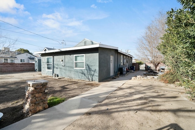 exterior space with central AC unit and a patio