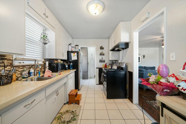 kitchen with white cabinetry, sink, black electric range oven, ventilation hood, and decorative backsplash