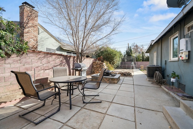 view of patio / terrace with a grill, cooling unit, and a trampoline