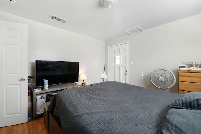 bedroom with dark hardwood / wood-style floors