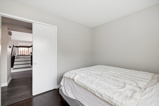 bedroom with dark wood-type flooring