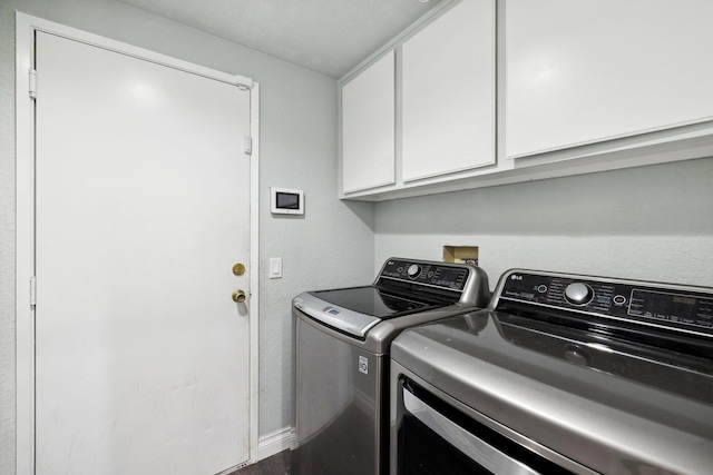 laundry area featuring cabinets and separate washer and dryer