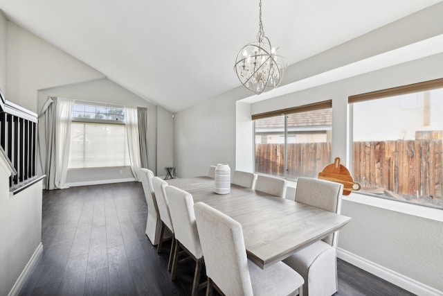 dining space featuring a chandelier, dark hardwood / wood-style floors, and lofted ceiling