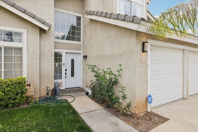 doorway to property with a garage