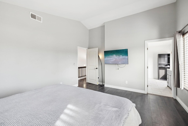 bedroom with dark wood-type flooring and high vaulted ceiling