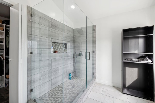 bathroom with lofted ceiling and a shower with shower door