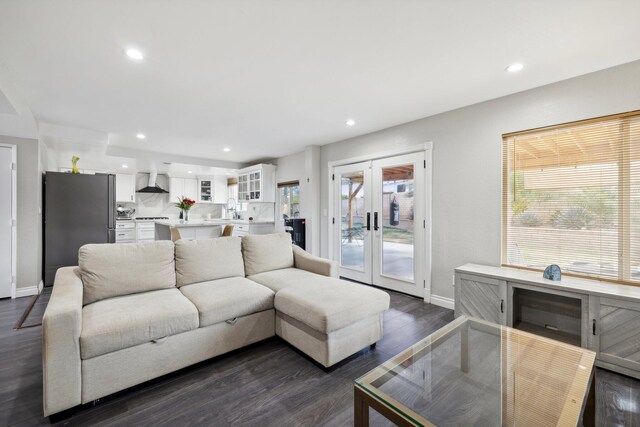 living room with dark hardwood / wood-style floors, sink, and french doors