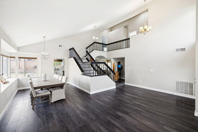 dining area featuring dark hardwood / wood-style flooring, high vaulted ceiling, and a notable chandelier